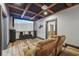 Media room featuring a large screen, projector, theater seating, and a wood beamed ceiling at 2945 Ashbyrn Ct, Buford, GA 30519