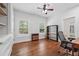 Bright office space with hardwood floors, natural light, and ample storage and shelving at 2945 Ashbyrn Ct, Buford, GA 30519