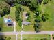Wide aerial shot showcasing home's location, sizable lot with in-ground pool, quiet suburban street, and mature trees at 315 Pleasant Grove Rd, Mcdonough, GA 30252