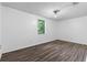 Bedroom featuring wood-look flooring, white walls, and natural light at 315 Pleasant Grove Rd, Mcdonough, GA 30252