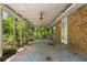 Spacious covered patio area with brick wall and concrete floor, great for outdoor relaxation or entertaining at 315 Pleasant Grove Rd, Mcdonough, GA 30252