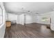 Large living area with updated floors, ample light, and brick fireplace in need of repair at 315 Pleasant Grove Rd, Mcdonough, GA 30252