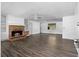 Bright living room with a brick fireplace, built-in shelving, and stylish flooring at 315 Pleasant Grove Rd, Mcdonough, GA 30252