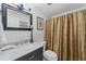 Stylish bathroom with white marble vanity top, dark cabinets, and patterned shower curtain at 3287 Alton Rd, Atlanta, GA 30341