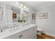 Bright bathroom with double sinks, white cabinets, and wood floor at 3287 Alton Rd, Atlanta, GA 30341