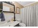 Bathroom featuring a large framed mirror, white tiled walls, and a shower at 3287 Alton Rd, Atlanta, GA 30341