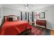 Cozy bedroom with red bedding, antique furniture, and a decorative rug at 3287 Alton Rd, Atlanta, GA 30341