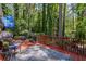 Wood deck with chairs and table overlooking a wooded backyard at 3287 Alton Rd, Atlanta, GA 30341