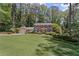 Traditional brick home with lush, green lawn, attached garage, and mature trees providing shade at 3287 Alton Rd, Atlanta, GA 30341