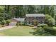 Beautiful two-story brick home with a well-maintained lawn, blue shutters, and a bright yellow door at 3287 Alton Rd, Atlanta, GA 30341