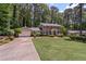 Charming two-story brick home with a well-manicured lawn, mature trees, and blue shutters at 3287 Alton Rd, Atlanta, GA 30341