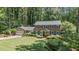 Attractive two-story brick home featuring a lush front yard, manicured landscaping, and a two-car garage at 3287 Alton Rd, Atlanta, GA 30341