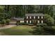Elegant two-story brick house with green lawn, neat landscaping and a two car garage at 3287 Alton Rd, Atlanta, GA 30341