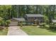 Beautiful two-story brick home featuring a lush front yard, manicured landscaping, and a two-car garage at 3287 Alton Rd, Atlanta, GA 30341