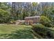 Beautiful two-story brick home featuring a lush front yard, manicured landscaping, and blue shutters at 3287 Alton Rd, Atlanta, GA 30341