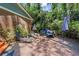 Brick patio with lounge chairs, table and grill surrounded by trees at 3287 Alton Rd, Atlanta, GA 30341