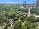 An aerial view of a house surrounded by trees with skyscrapers in the background at 3809 Wieuca Ne Rd, Atlanta, GA 30342
