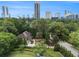 An aerial view shows the house, a side street, and the downtown skyline at 3809 Wieuca Ne Rd, Atlanta, GA 30342