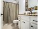 Neutral toned bathroom, features tile flooring, granite counters and a shower-tub combo with curtain at 3809 Wieuca Ne Rd, Atlanta, GA 30342