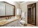 Well-lit bathroom with granite countertops, modern fixtures, and a glass-enclosed shower at 3809 Wieuca Ne Rd, Atlanta, GA 30342