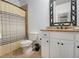 Bathroom with granite counters, tile flooring and tub/shower combination with grey and yellow curtain at 3809 Wieuca Ne Rd, Atlanta, GA 30342