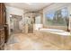 Luxurious bathroom featuring a soaking tub, glass shower, and travertine tile floors at 3809 Wieuca Ne Rd, Atlanta, GA 30342