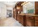 Bathroom view showcasing wood cabinets, granite countertops, and access to the main bedroom at 3809 Wieuca Ne Rd, Atlanta, GA 30342