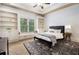 Bright bedroom featuring built-in shelving, neutral tones, plush rug, ceiling fan and a window seat at 3809 Wieuca Ne Rd, Atlanta, GA 30342