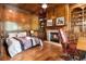 Cozy bedroom with hardwood floors, fireplace, built-in shelves, and wood-paneled walls at 3809 Wieuca Ne Rd, Atlanta, GA 30342