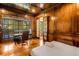 Bedroom with hardwood floors, wood-paneled walls, desk, and a large window at 3809 Wieuca Ne Rd, Atlanta, GA 30342