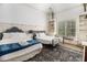 Bright bedroom with two beds, large window, and built-in shelving, offering a cozy retreat at 3809 Wieuca Ne Rd, Atlanta, GA 30342