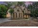 Stunning stone and brick home with a well-manicured lawn and a circular driveway at 3809 Wieuca Ne Rd, Atlanta, GA 30342