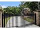 Secure gated entrance to the property with brick pillars and wrought iron fencing for privacy at 3809 Wieuca Ne Rd, Atlanta, GA 30342
