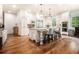 Bright kitchen with white cabinetry, stainless steel appliances, a center island and hardwood flooring at 3809 Wieuca Ne Rd, Atlanta, GA 30342