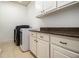 Laundry room includes cabinetry for storage, modern washer and dryer set, and counter space at 3809 Wieuca Ne Rd, Atlanta, GA 30342