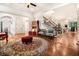 Elegant living room boasts hardwood floors, decorative rug, and an open staircase to the second floor at 3809 Wieuca Ne Rd, Atlanta, GA 30342