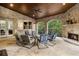 Outdoor patio with a stone fireplace, comfortable seating, and a wooded view at 3809 Wieuca Ne Rd, Atlanta, GA 30342