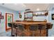 A stunning home bar features counter seating, a stocked back bar, and a stylish decor at 530 Twinflower Ct, Roswell, GA 30075