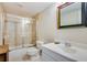 Bathroom featuring tiled shower with glass door, vanity with sink, mirror, and modern fixtures at 530 Twinflower Ct, Roswell, GA 30075