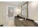 Bathroom featuring granite countertop, vanity and tiled shower-tub combination at 530 Twinflower Ct, Roswell, GA 30075
