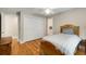 This bedroom features a ceiling fan, closet, and hardwood floors at 530 Twinflower Ct, Roswell, GA 30075