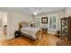 Bedroom featuring hardwood floors, two large windows with shutters, and classic furnishings at 530 Twinflower Ct, Roswell, GA 30075