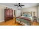 Cozy bedroom offers hardwood floors, ceiling fan, and neutral walls at 530 Twinflower Ct, Roswell, GA 30075
