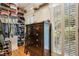 Walk-in closet with custom shelving and drawers for optimal organization plus a dark wood dresser at 530 Twinflower Ct, Roswell, GA 30075