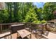 Private deck with outdoor seating overlooking the backyard oasis and swimming pool at 530 Twinflower Ct, Roswell, GA 30075