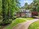 Traditional two-story home with a brick facade, manicured lawn, and mature trees providing a classic curb appeal at 530 Twinflower Ct, Roswell, GA 30075