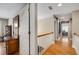 Hallway featuring wood flooring and banister at 530 Twinflower Ct, Roswell, GA 30075