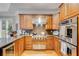 Well-equipped kitchen with stainless steel appliances, custom cabinets, and ample counter space at 530 Twinflower Ct, Roswell, GA 30075