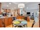 Open kitchen featuring wood cabinets, stainless steel appliances, and an adjacent dining area at 530 Twinflower Ct, Roswell, GA 30075