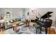 Cozy living room with plush sofa, fireplace, and grand piano, perfect for relaxing or entertaining at 530 Twinflower Ct, Roswell, GA 30075